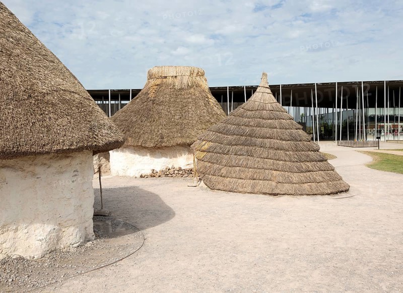 Reconstruction of neolithic homes thatched round houses huts, Stonehenge, Wiltshire, England, UK new visitor centre