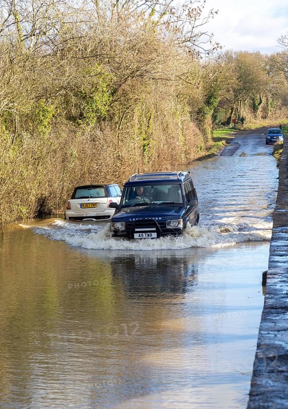 Land Rover Discovery Td5 vehicle driving through flood water at Kellaways, Wiltshire, England, UK 24/12/20