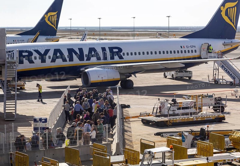 Passengers held back people waiting to board a Ryanair plane flight Faro airport, Portugal, Europe