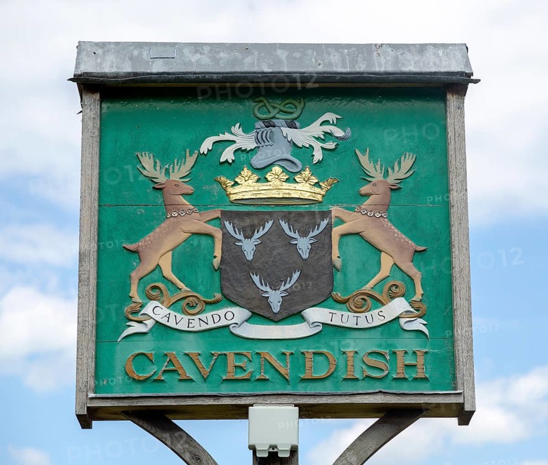 Village sign coat of arms heraldry, Cavendish, Suffolk, England, UK