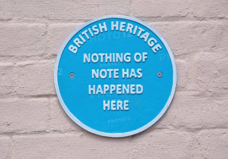 Humorous fake blue plaque sign on wall of house 'British Heritage Nothing of Note Has Happened Here'