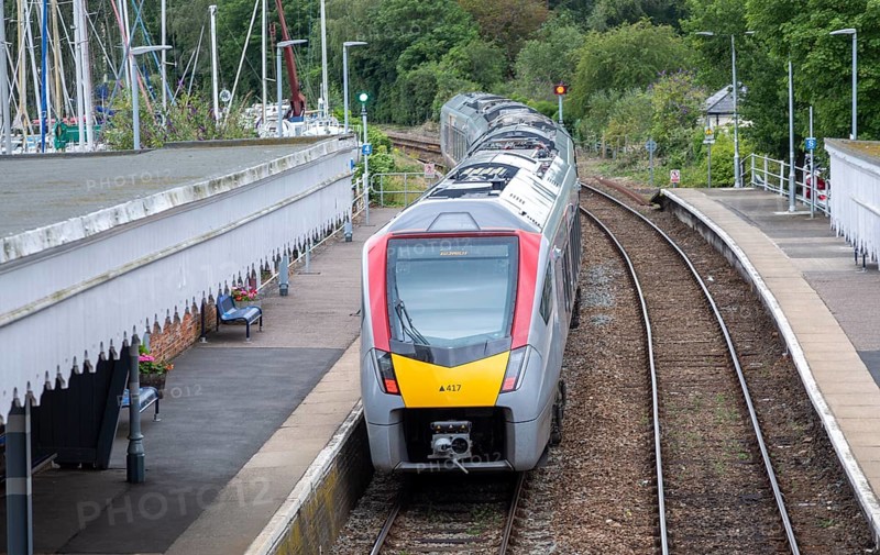 British Rail Class 755 Stadler bi-modal train leaving railway station at Woodbridge, Suffolk, England, UK destination Ipswich
