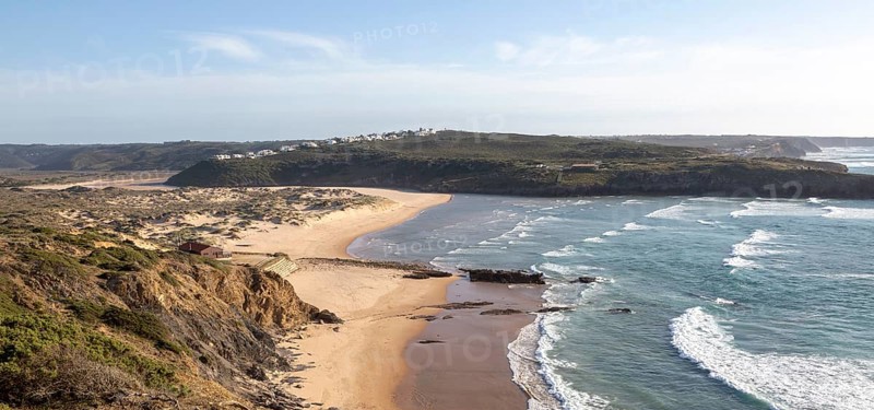 Panorama view of river mouth of Ribeira de Aljezur reaching the Atlantic Ocean and whitewashed buildings of Clero village, Aljezur, Algarve, Portugal, Southern Europe, Europe