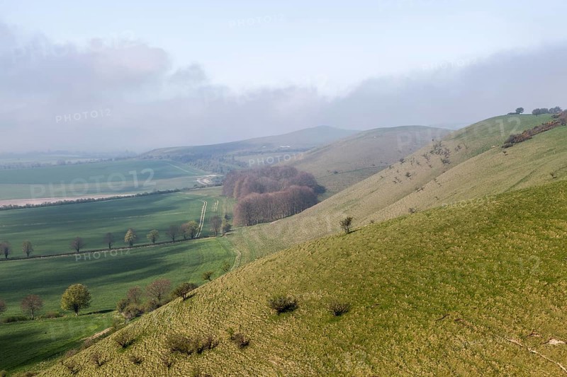 Fog clearing from chalk downs scarp slope Pewsey Vale, near Knap Hill, Alton Barnes, Wiltshire, England, UK