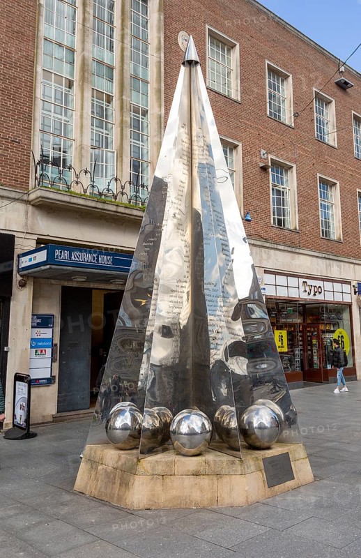 Riddle sculpture by Michael Fairfax, High Street, Exeter city centre, Devon, England, UK