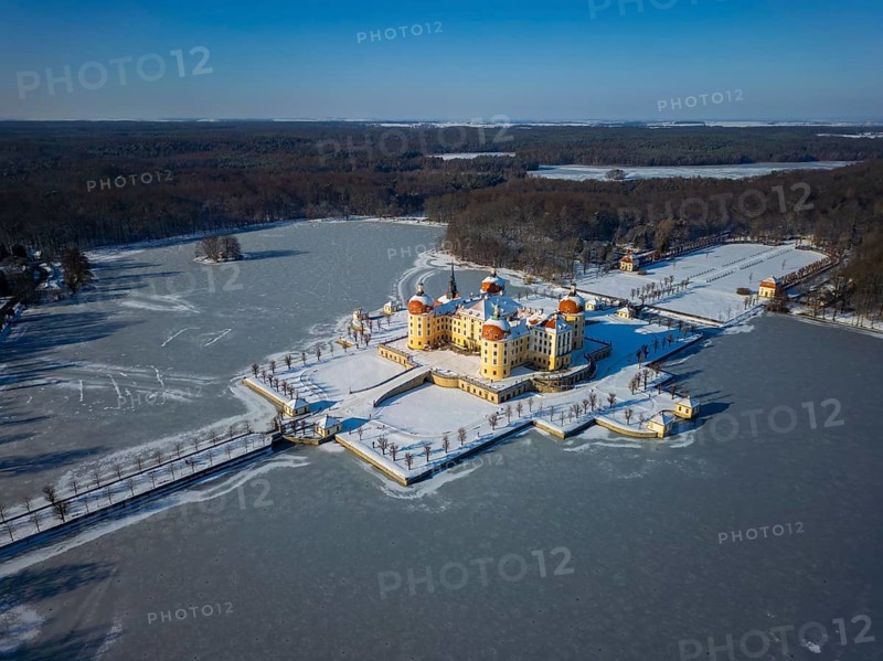 Moritzburg Castle on the castle island surrounded by the frozen castle pond, Moritzburg, Saxony, Germany, Europe