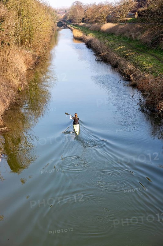 Female canoeist practising on Kennet and Avon canal, Devizes, Wiltshire, England, UK