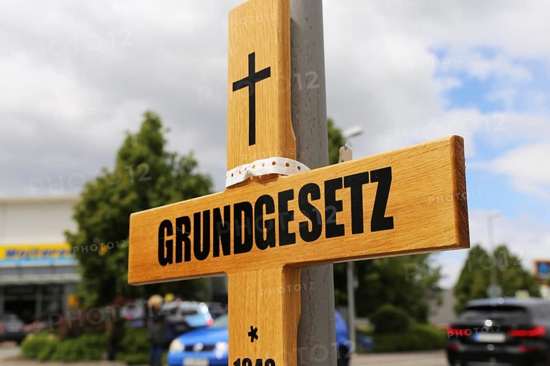 Symbolic grave cross with inscription on the Basic Law at a protest organised by critics of the corona measures in Ludwigshafen, Rhineland-Palatinate