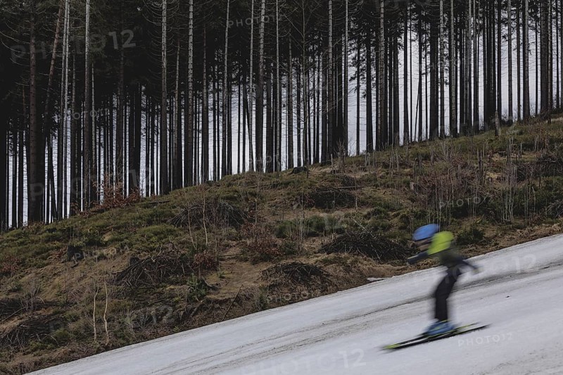 A skier skis on an artificially snow-covered and dirty slope, taken on a ski slope in the Jizera Mountains ski resort near Albrechtice v Jizerskych Horach, 05.02.2024. The Czech low mountain range with its ski resort is affected by increasingly warmer and shorter winters