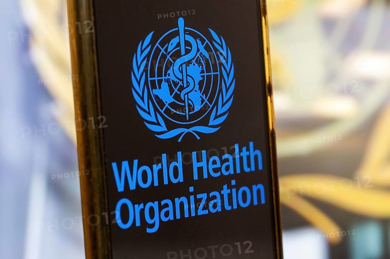 Symbolic image: Smartphone with WHO (World Health Organisation) logo against a blurred background