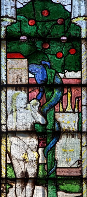 Sixteenth century stained glass windows inside church of Saint Mary, Fairford, Gloucestershire, England, UK, window 1 detail Fall of Eve in Garden of Eden, serpent, apple tree