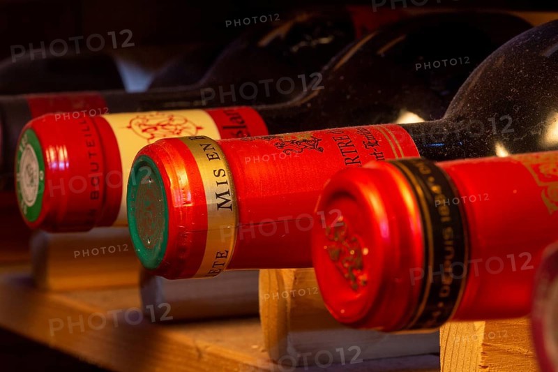 Wine cellar with red wine bottles (editorial)