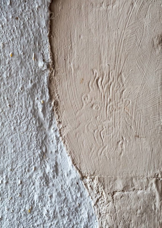 Village parish church of All Saints, Sutton, Suffolk, England, UK medieval imp devil figure in wall plaster