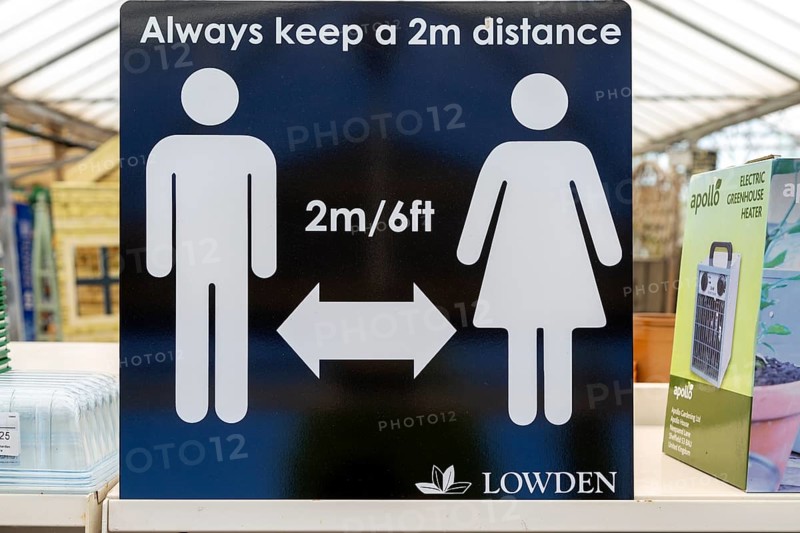 Social Distancing 2 metres apart information notice sign in Lowden garden centre shop, Wiltshire, England, UK, May 2020
