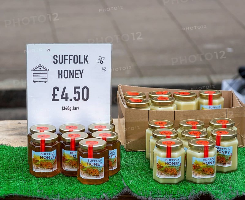 Display of jars of Suffolk honey on sale at street market, England, UK