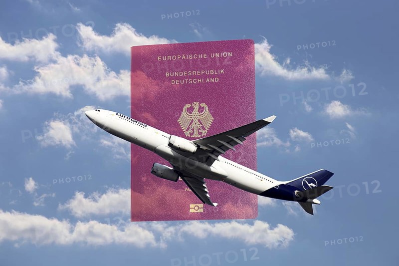 Symbolic image: Lufthansa passenger aircraft taking off, in the background a passport of the Federal Republic of Germany