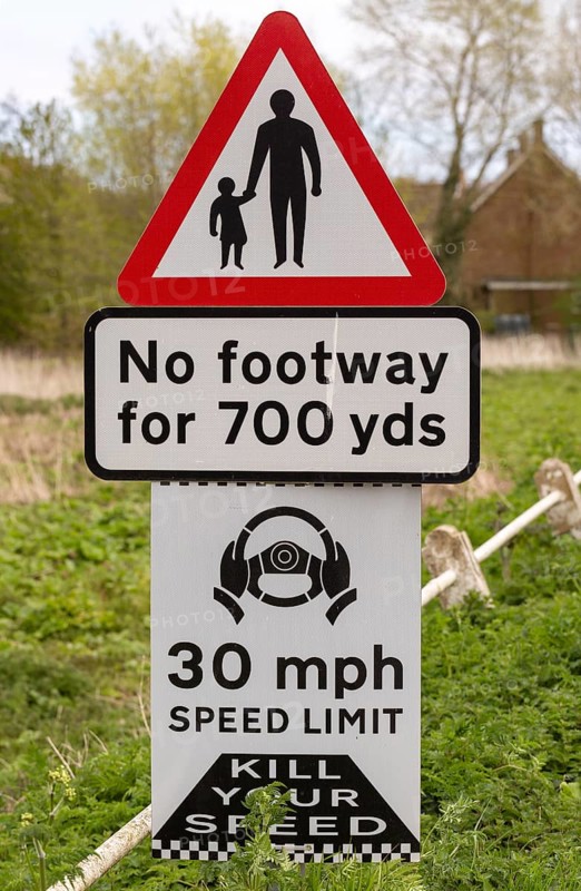 Road traffic signs warning of hazards no footway 30 mph speed limit, Shottisham, Suffolk, England, UK