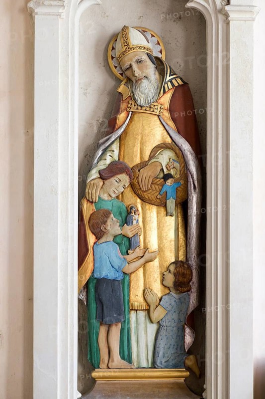 Sculpture statue of Saint Nicholas with children inside village parish church of Saint Nicholas, Hintlesham, Suffolk, England, UK