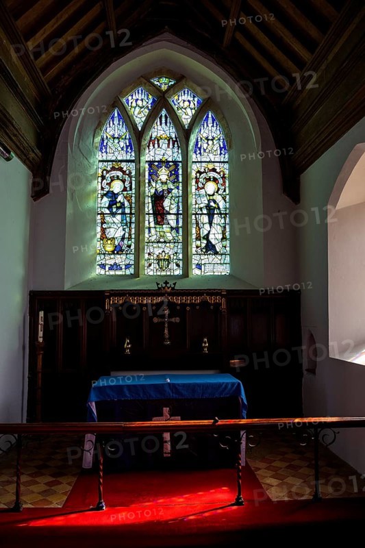 Holton church, Suffolk, England, UK stained glass east window c 1899 by Kempe Saint Mary, Jesus Christ and Saint Peter altar reredos