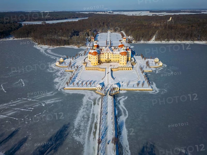 Moritzburg Castle on the castle island surrounded by the frozen castle pond, Moritzburg, Saxony, Germany, Europe