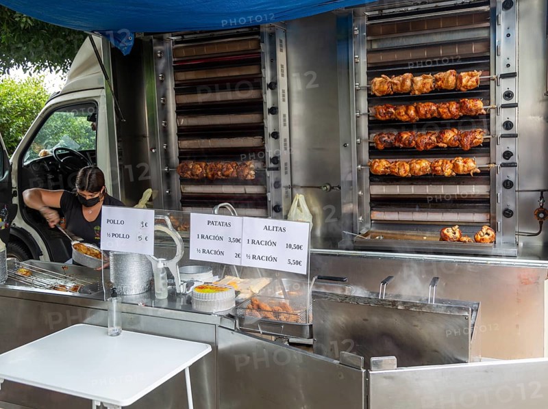 Mobile shop vehicle selling spit roasted chicken products from van, Mojacar, Almeria, Spain, Europe