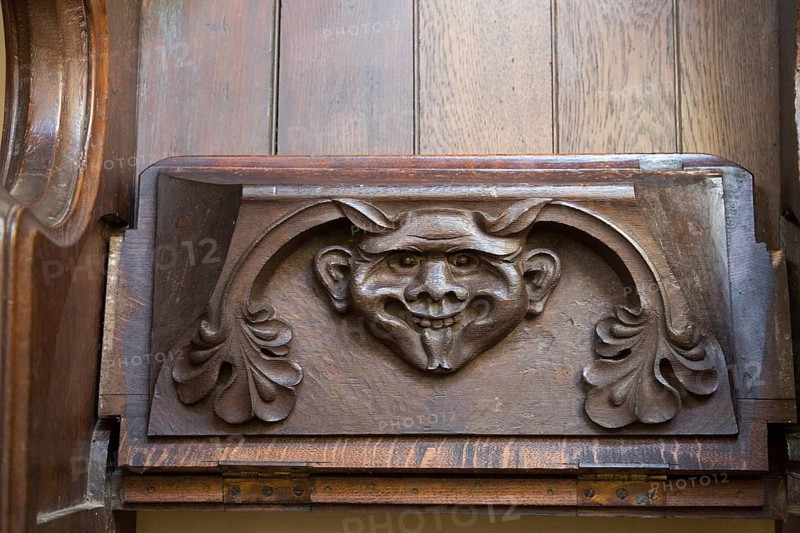 Church of Saint Mary of the Assumption, Ufford, Suffolk, England, UK grotesque devil face on misericord bench seat