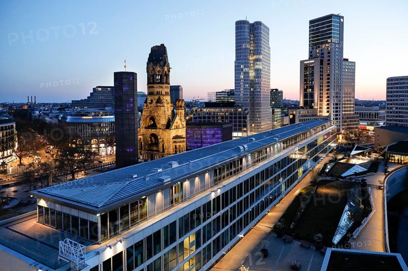 View of Breitscheidplatz in the evening with the Bikini building, the Kaiser Wilhelm Memorial Church, the Walldorf Astoria Hotel and the Upper West skyscraper, Berlin, 27.04.2021