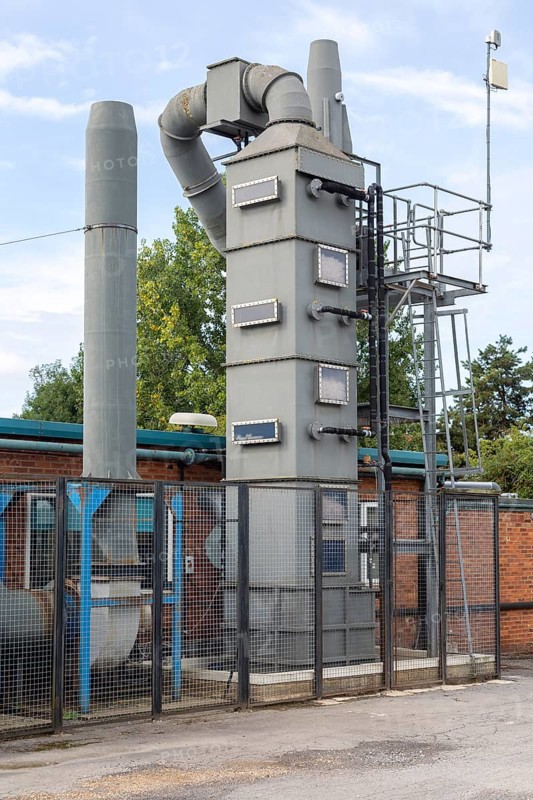 Exhaust gas air purification tower at small specialist steel firm, Calne, England, UK