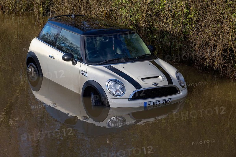 Mini Cooper S car stuck in River Avon flood water, Kellaways bridge, Wiltshire, England, UK 24/12/20