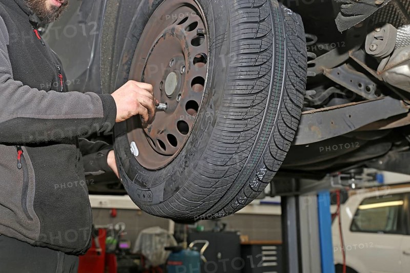 Fitting new all-weather tyres in the garage (editorial)