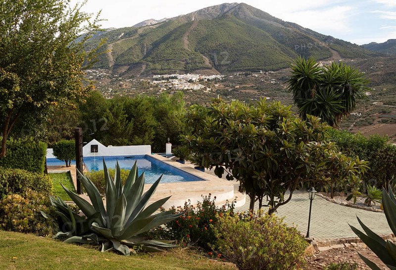 Swimming pool in garden small hotel view to Alcaucin village and Maroma mountain, Sierra de Tejeda, Axarquia, Spain, Europe