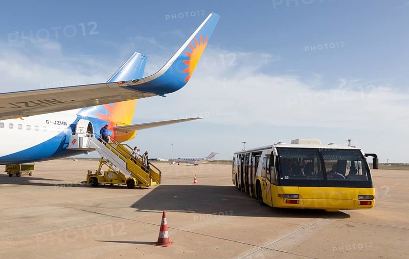 Jet2 package holiday plane passengers disembarking at the airport Faro, Algarve, Portugal with extra wide transport bus
