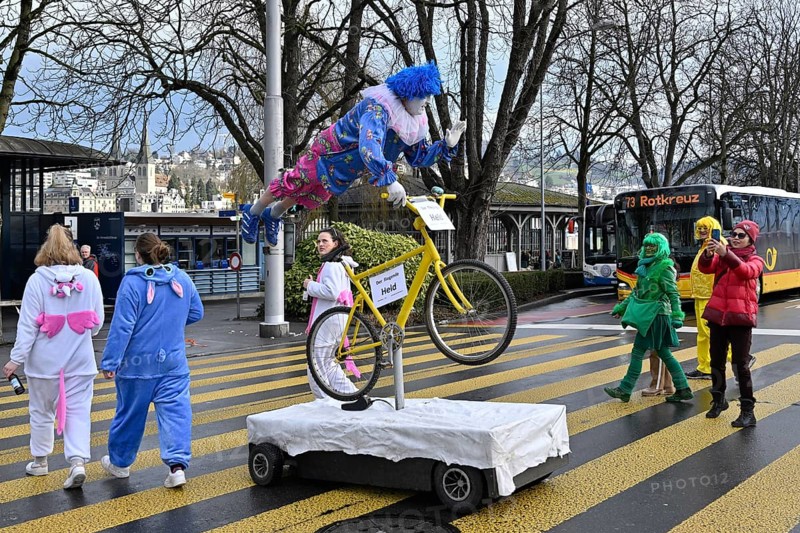 Carnival reveller flying hero on bicycle