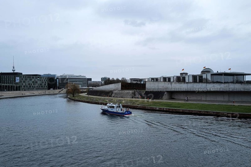 A police boat travels up the River Spree close to the German Bundestag building on a day of widespread protests. Berlin, Germany, Europe