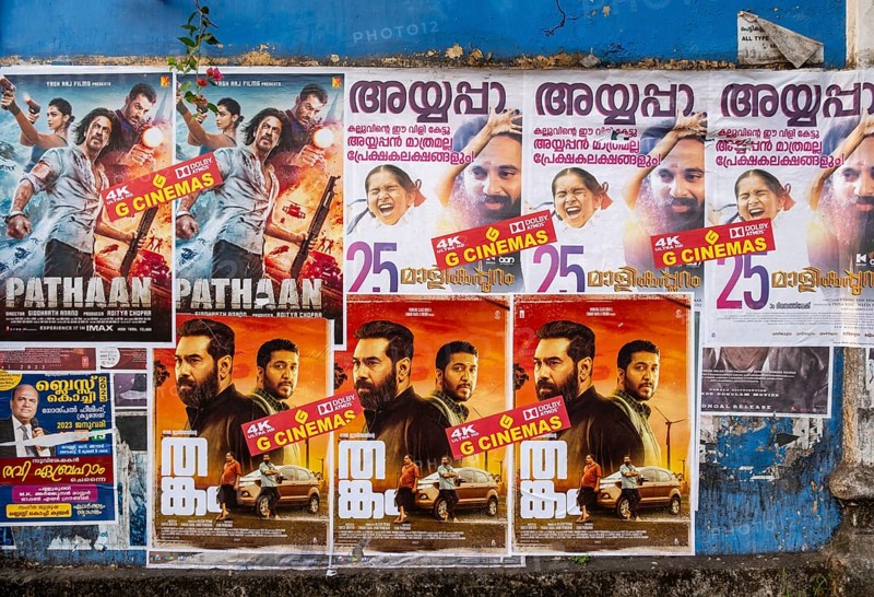 Rows of vibrant Indian Bollywood movie posters adorn a wall in Fort Kochi, Cochin, Kerala, India, Asia