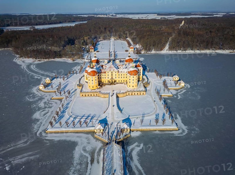Moritzburg Castle on the castle island surrounded by the frozen castle pond, Moritzburg, Saxony, Germany, Europe