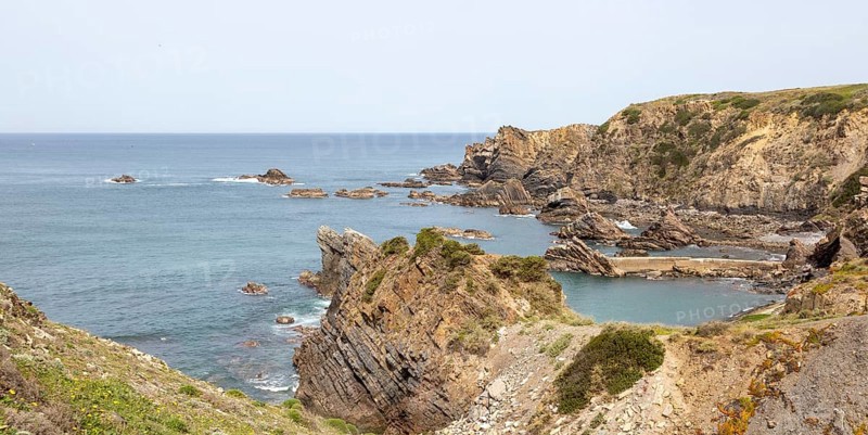 Rocky rugged coastline near fishing port village of Azenha do Mar, Alentejo Littoral, Portugal, southern Europe, Europe