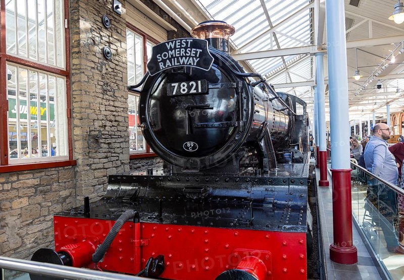 Old steam engine McArthur Glen designer outlet former railway works, Swindon, Wiltshire, England, UK, West Somerset Railway train 7821 Ditcheat Manor