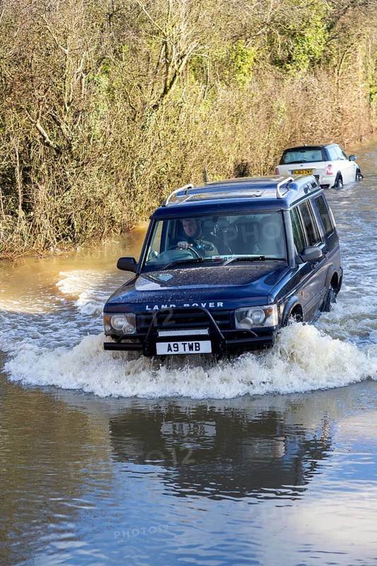 Land Rover Discovery Td5 vehicle driving through flood water at Kellaways, Wiltshire, England, UK 24/12/20