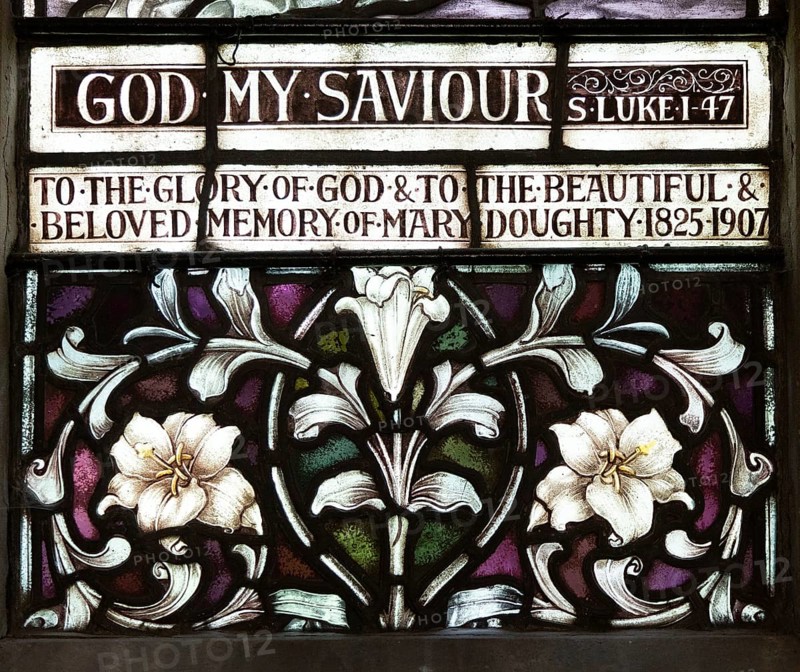 Stained glass window church of Saint Mary, Martlesham, Suffolk, England, UK by Heaton, Butler and Bayne early 1900s lilies floral decoration design detail