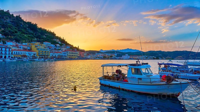 Harbour view at sunset with boats and glowing water reflections, Gythio, Mani, Peloponnese, Greece, Europe