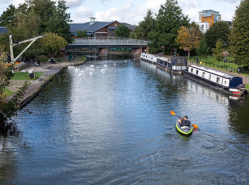 Narrow boats and kayak Kennet and Avon canal in the town centre of Newbury, Berkshire, England, UK
