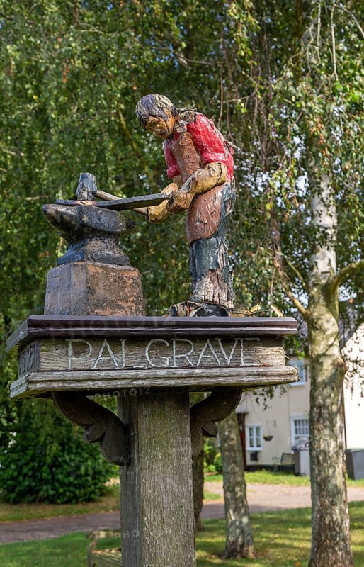 Model of blacksmith working on village sign for Palgrave, Suffolk, England, UK
