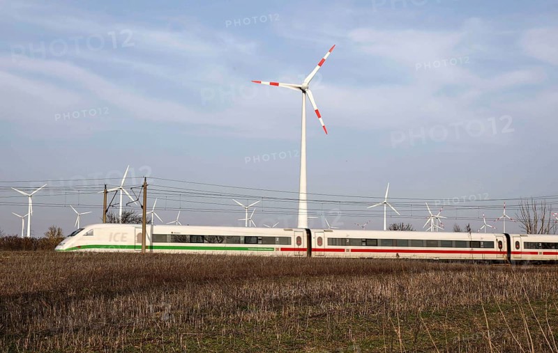 Deutsche Bahn ICE train passes a wind farm, Nauen, 03/03/2021