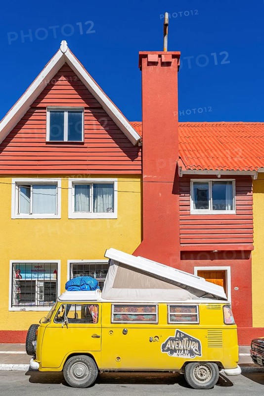 Yellow Volkswagen van in retro style in front of a yellow and red house, Ushuaia, Tierra del Fuego Island, Patagonia, Argentina, South America