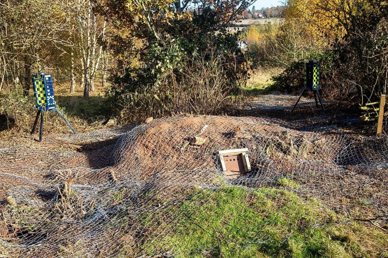 Eviction of badgers clearance of badger sett using metal fencing and one way exit gates, part of HS2 project near Kenilworth, Warwickshire, England, November 2020. Armadillo Videoguard surveillance robots used to observe site and detect protestors