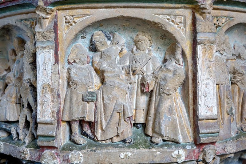 Traces of medieval paint on seven sacrament font, panel depicting matrimony, church of Saint Andrew, Westhall, Suffolk, England, UK
