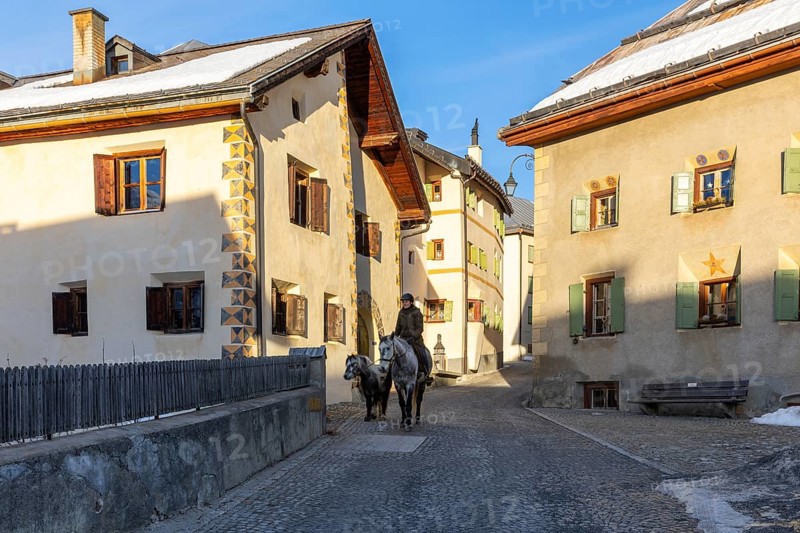 Horsewoman on horseback, historic houses, sgraffito, facade decorations, historic village, Guarda, Engadin, Grisons, Switzerland, Europe