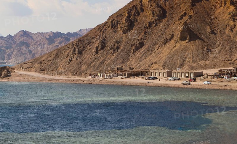 The coastline of the Red Sea with small resorts and the mountains in the background. Coral reef Blue Hole. Egypt, the Sinai Peninsula, Dahab