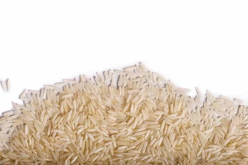 Texture of basmati rice isolated on white background. Top view. Copy space